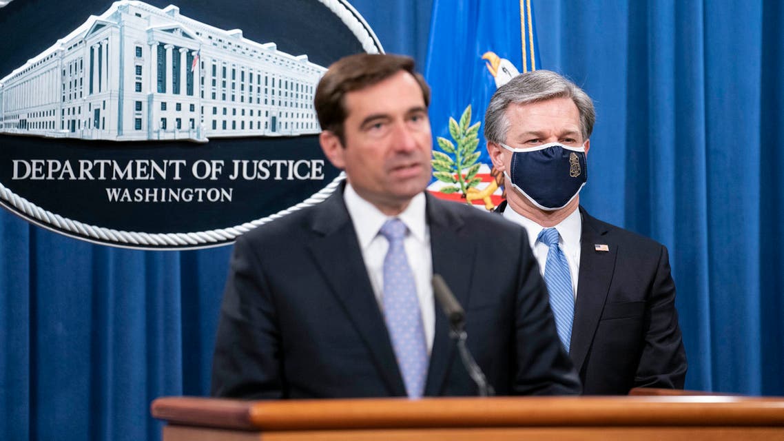 Assistant Attorney General for National Security John C. Demers, left, and FBI Director Christopher Wray participate in a virtual news conference at the Department of Justice on October 28, 2020 in Washington, DC. Eight people have been arrested as part of Operation Fox Hunt, an effort by the People's Republic of China to threaten people to return to the country. (Photo by Sarah Silbiger/Getty Images)