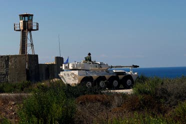 A UN peacekeeper sits atop a tank near the office where Israel and Lebanon meet for indirect talks, in south Lebanon’s Naqoura, October 14, 2020. (AP)