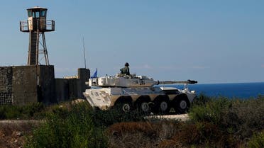 A UN peacekeeper sits atop a tank near the office where Israel and Lebanon meet for indirect talks, in south Lebanon’s Naqoura, Oct. 14, 2020. (AP)