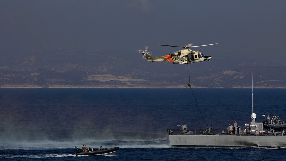 A Cypriot special forces soldier fast-rope down from a hovering helicopter onto the deck of a supposed hijacked vessel as part of a joint naval drill between the U.K., Cyprus and France off Limassol, Cyprus on Tuesday, October 27, 2020. Britain's largest-ever naval deployment off Cyprus for decades is making its presence felt in the volatile region and underscores what officials said is the country's post-Brexit commitment to buttressing Europe's security. (AP Photo/Petros Karadjias)