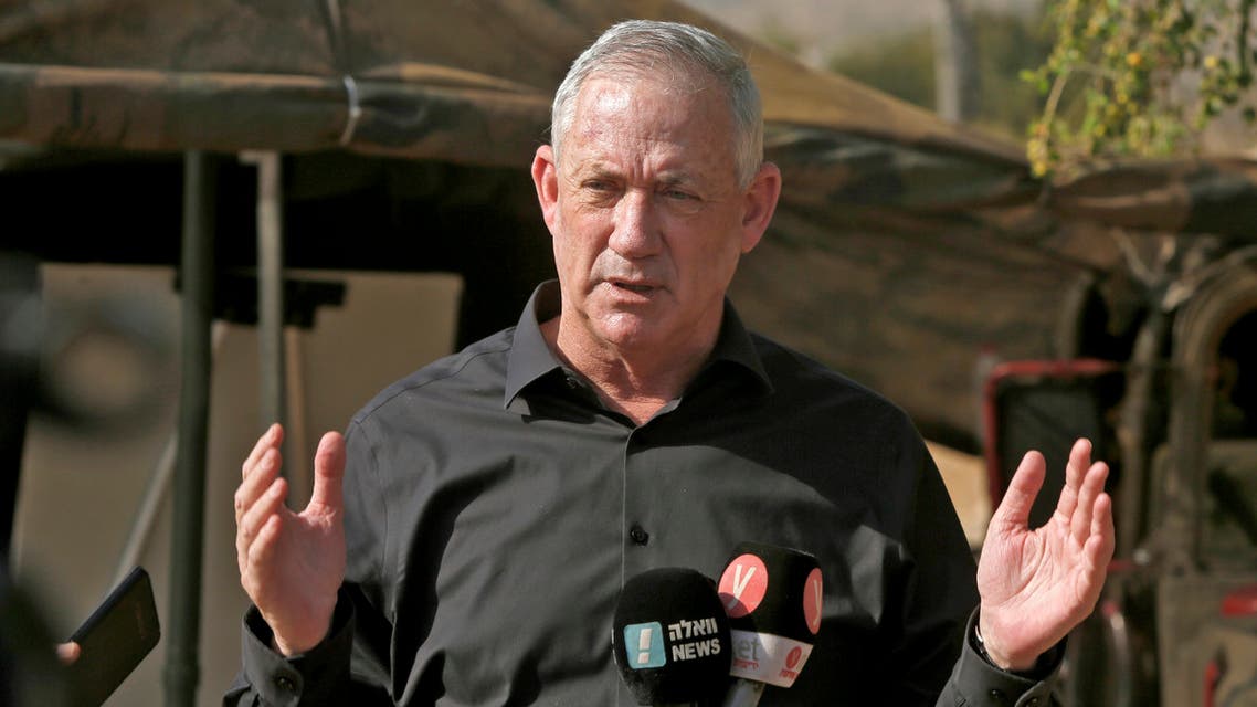 Benny Gantz (R), Israel's Alternate Prime Minister and Defence Minister, mask-clad due to the COVID-19 coronavirus pandemic, arrives to attend the Deadly Arrow military drill near Kibbutz Ravid in the northern part of Israel on October 27, 2020. The largest military drill of the year, Deadly Arrow is meant to simulate a war against Hezbollah as part of efforts to improve the Israeli military's attack capabilities.