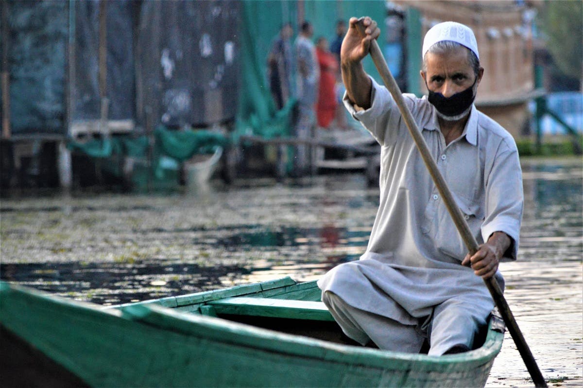 A man rows his boat on Dal Lake in Srinagar, Kashmir, India. (Reuters)