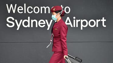 (FILES) In this file photo taken on April 2, 2020, a Qatar Airways crew member enters Sydney international airport to fly on a repatriation flight back to France amid the COVID-19 coronavirus pandemic. Revelations that passengers flying through Doha were forced to endure vaginal inspections have upended Qatar's efforts to boost its reputation before the Gulf state hosts World Cup 2022, experts say. Officers marched women off a Sydney-bound Qatar Airways flight earlier this month and forced them to undergo intimate examinations after a newborn baby was found abandoned in an airport bathroom.