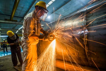 A worker welds medal truck parts at a factory in Weifang in China's eastern Shandong province on August 14, 2020. (AFP)