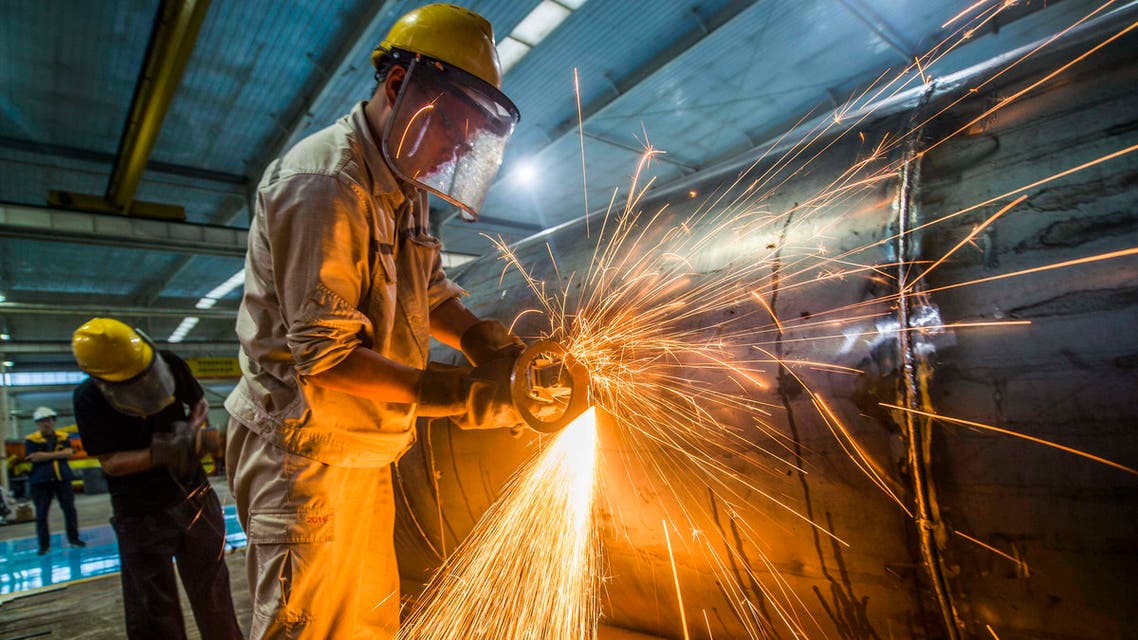 A worker welds medal truck parts at a factory in Weifang in China's eastern Shandong province on August 14, 2020. (AFP)