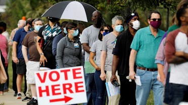 Voters wait in line to enter a polling place and cast their ballots on the first day of the state's in-person early voting for the general elections in North Carolina, Oct. 15, 2020. (Reuters)
