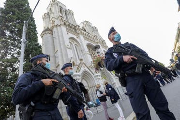 Police officers stand guard by the Notre-Dame de l'Assomption Basilica in Nice on October 29, 2020. (AFP)