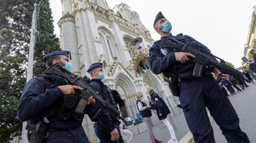 Police officers stand guard by the Notre-Dame de l'Assomption Basilica in Nice on October 29, 2020. (AFP)