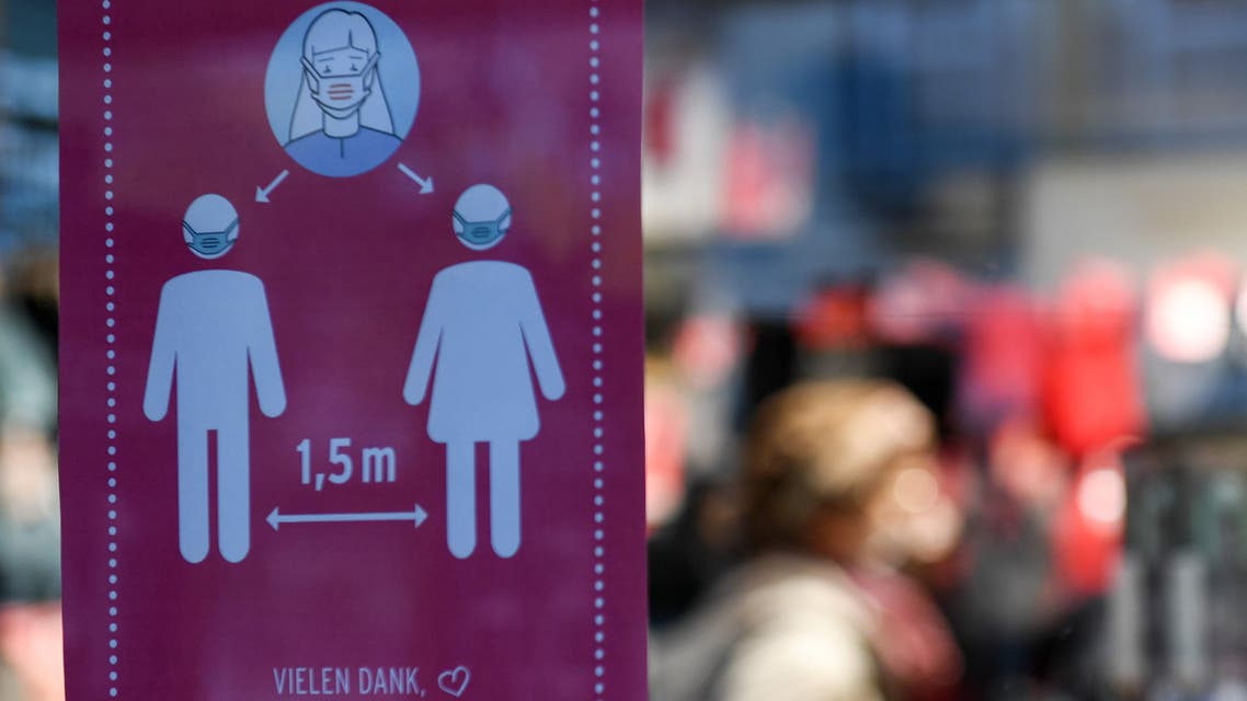 An information poster on social distancing measures during the novel coronavirus (Covid-19) pandemic is seen in a store window in the city of Nuremberg, southern Germany, on October 28, 2020. Germany on October 28 ordered a new round of shutdowns for the cultural, leisure as well as food and drink sectors, in a bid to halt a surge in new coronavirus infections.
