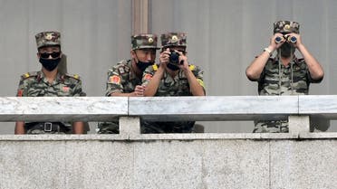 North Korean soldiers look toward the south side of Panmunjom in the Demilitarized Zone (DMZ) dividing the two Koreas on September 16, 2020. (AFP)