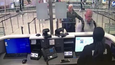 This handout video grab image released by The Istanbul Police Department on January 17, 2020, shows Michael Taylor (2R) and George Antoine Zayek (C) at passport control in Istanbul Airport. (AFP)