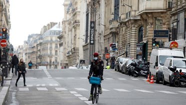 2020-10A man rides a bicycle in an almoste deserted street in Paris on the first day of the second national lockdown as part of the COVID-19 measures to fight a second wave of the coronavirus disease (COVID-19), France, October 30, 2020. (Reuters)-30T122453Z_1626020540_RC20TJ9ZO97X_RTRMADP_3_HEALTH-CORONAVIRUS-FRANCE-LOCKDOWN