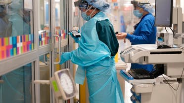 Medical personnel don PPE while attending to a patient (not infected with COVID-19) at Bellevue Hospital in New York, Oct. 28, 2020.