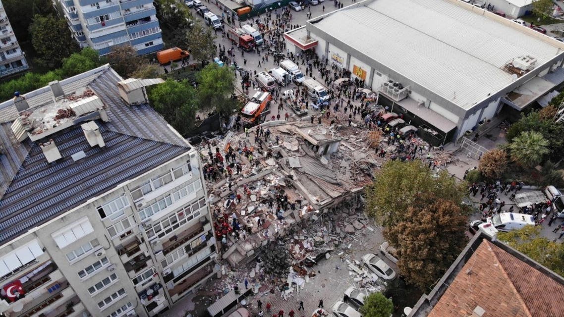 Rescuers search for survivors at a collapsed building after a powerful earthquake struck Turkey's western coast and parts of Greece, in Izmir, on October 30, 2020. (AFP)