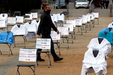 -Nurse clothes and signs are displayed during a symbolic action by the European Federation of Public Service Unions (EPSU), calling EU leaders to fund the health program budget in Brussels, as the spread of the coronavirus continues, in Brussels, Belgium, on October 29, 2020. (Reuters)