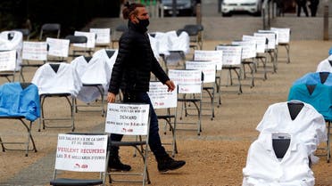 Nurse clothes and signs are displayed during a symbolic action by the European Federation of Public Service Unions (EPSU), calling EU leaders to fund the health program budget in Brussels, amid the coronavirus spread, Brussels, Belgium, on October 29, 2020. (Reuters)