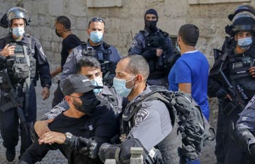 Members of the Israeli security forces restrict a Palestinian taking part in a protest against the French president, in the al-Aqsa mosque compound, in the Old City of Jerusalem on October 30, 2020. (AFP)