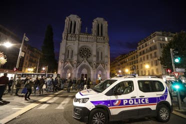 A Police vehicle is parked by the Notre-Dame de l'Assomption Basilica in Nice on October 29, 2020. (AFP)
