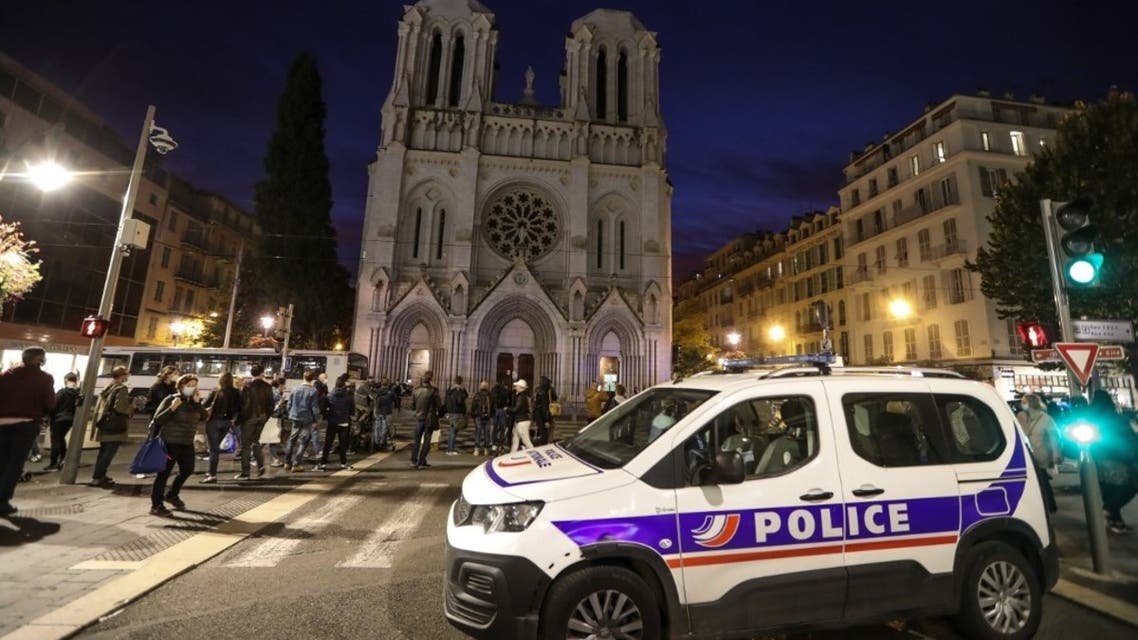 A Police vehicle is parked by the Notre-Dame de l'Assomption Basilica in Nice on October 29, 2020. (AFP)