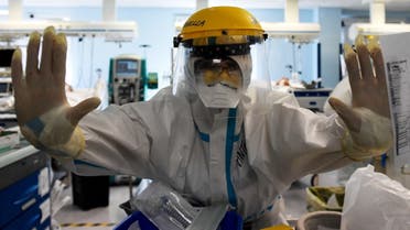 A member of medical staff wearing PPE reacts in the Intensive Care Unit (ICU) for the Covid-19 cases, in the San Filippo Neri hospital in Rome, Oct. 29, 2020. (AFP)