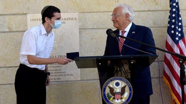 US Ambassador to Israel David Friedman presents Menachem Zivotofsky, a US citizen born in Jerusalem, his passport that lists Israel as birthplace at the US Embassy in Jerusalem, Oct. 30, 2020. (Reuters)