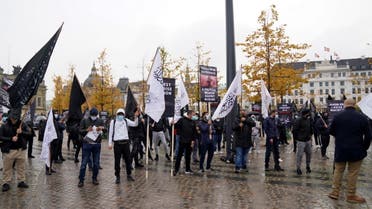 Protesters with flags and symbols of global Islamic political party Hizb ut-Tahrir demonstrate in front of the French Embassy on Kongens Nytorv in Copenhagen, Denmark, on October 30, 2020. (AFP)