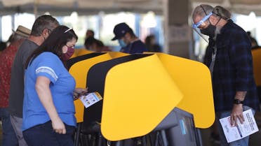 People vote in the US presidential election on the first day of expanded California in-person voting, amid the global outbreak of the coronavirus, at Dodger Stadium sports venue in Los Angeles, California, US, on October 30, 2020. (Reuters)