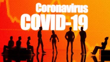 Small toy figures are seen in front of a Coronavirus Covid-19 and stock graph logo in this illustration taken, September 9, 2020. (Reuters)