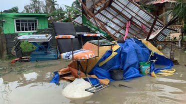 The remains of a barbershop is surrounded by floods in Pola town on the island of Mindoro, central Philippines on Oct. 26, 2020. (AP)