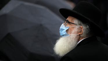 Rabbi Rafael Schaffer stands outside the Holocaust memorial during the National Holocaust Remembrance Day commemorations in Bucharest on Oct. 9, 2020. (AP)