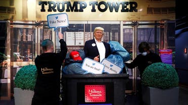 A wax figure depicting US President Donald Trump is put into a dumpster at Madame Tussauds in Berlin, Oct. 30, 2020. (Reuters)