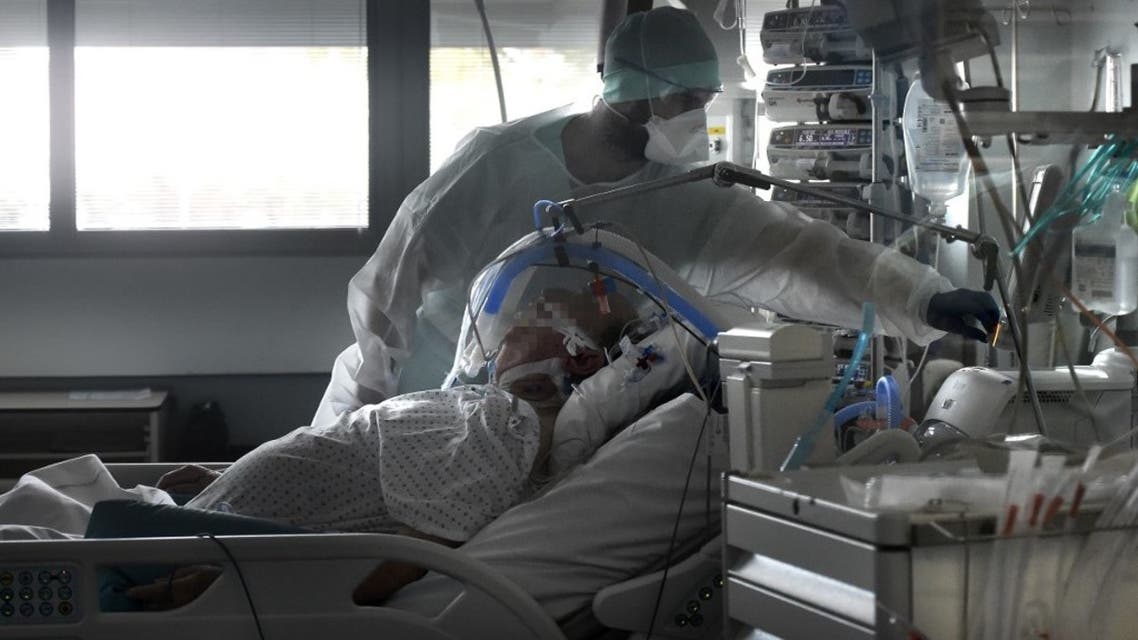 Medical staff tend to a patient in a level intensive care unit for patients infected with coronavirus at the University Hospital of Strasbourg (HUS) in Strasbourg, eastern France on October 22, 2020. (AFP)