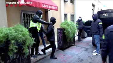 Catalan police officers arrest a man for praising the beheading of a French schoolteacher outside Paris this month, in this frame grab taken from Catalan police handout video shot on October 30, 2020, in Barcelona, Spain. (Reuters)