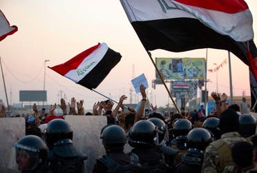 Iraqi anti-government protesters confront security forces as the latter attempt to break up a demonstration, remove their tents and reopen roads, in the southern city of Basra, on October 31, 2020. (AFP)