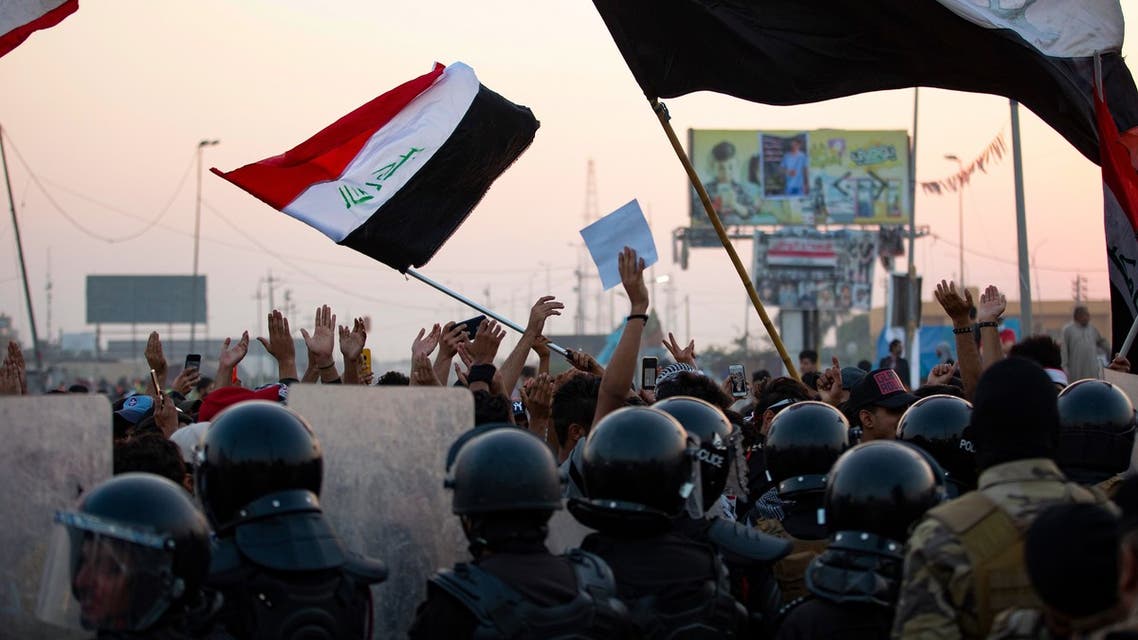 Iraqi anti-government protesters confront security forces as the latter attempt to break up a demonstration, remove their tents and reopen roads, in the southern city of Basra, on October 31, 2020.