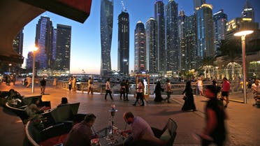 Two men play backgammon while smoking a shisha water pipe at a restaurant overlooking the canal and the Dubai Marina neighborhood in Dubai on May 1, 2015. (AP)