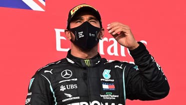 Mercedes’ Lewis Hamilton celebrates on the podium after winning the race at the Emilia Romagna Grand Prix in Imola, Italy, November 1, 2020. (Pool via Reuters/Miguel Medina)