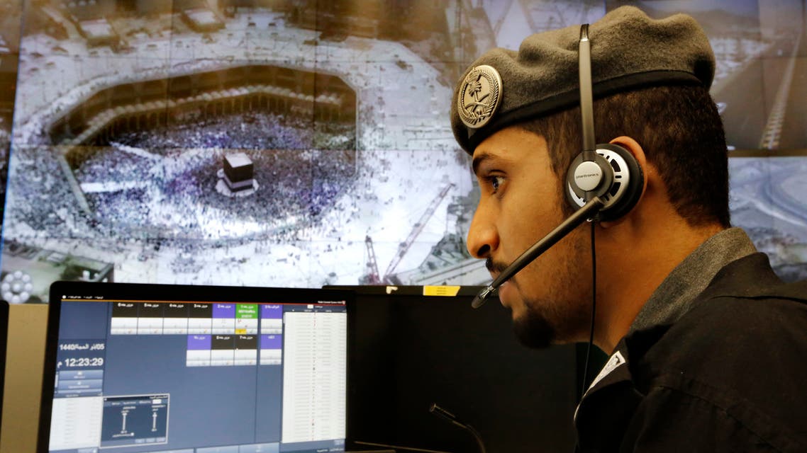 A Saudi Arabian police officer monitors screens displaying the Grand Mosque, at the 911 monitoring center, ahead of the Hajj pilgrimage in the city of Mecca on Aug. 6, 2019. (AP)