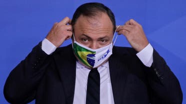 Brazilian Army General Eduardo Pazuello puts on a facemask during his inauguration ceremony as Minister of Health at the Planalto Palace, in Brasilia, on September 16, 2020. (AFP)