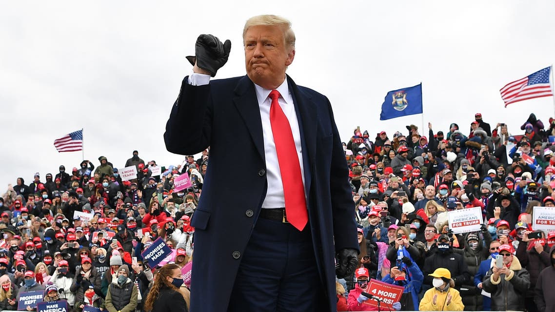 US President Donald Trump gestures onstage at a Make America Great Again rally at Oakland County International Airport, on October 30, 2020, in Waterford Township, Michigan. 