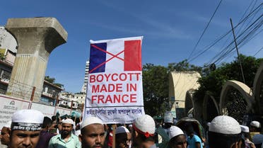 Protestors hold banners and shout slogans during a demonstration calling for the boycott of French products and denouncing French President Emmanuel Macron in Dhaka on October 30, 2020. (AFP)