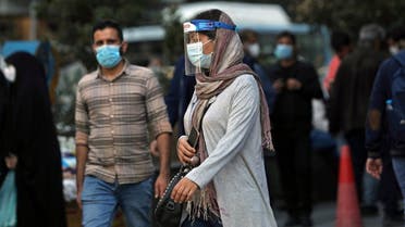 An Iranian woman wears a mask and face shield in Tehran, Iran October 24, 2020. (Majid Asgaripour/WANA via Reuters)
