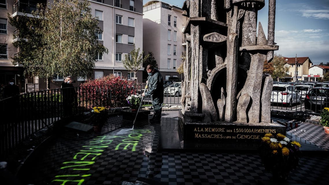 A man cleans the memorial for the Armenian genocide in Decines-Charpieu, near Lyon. (AFP)
