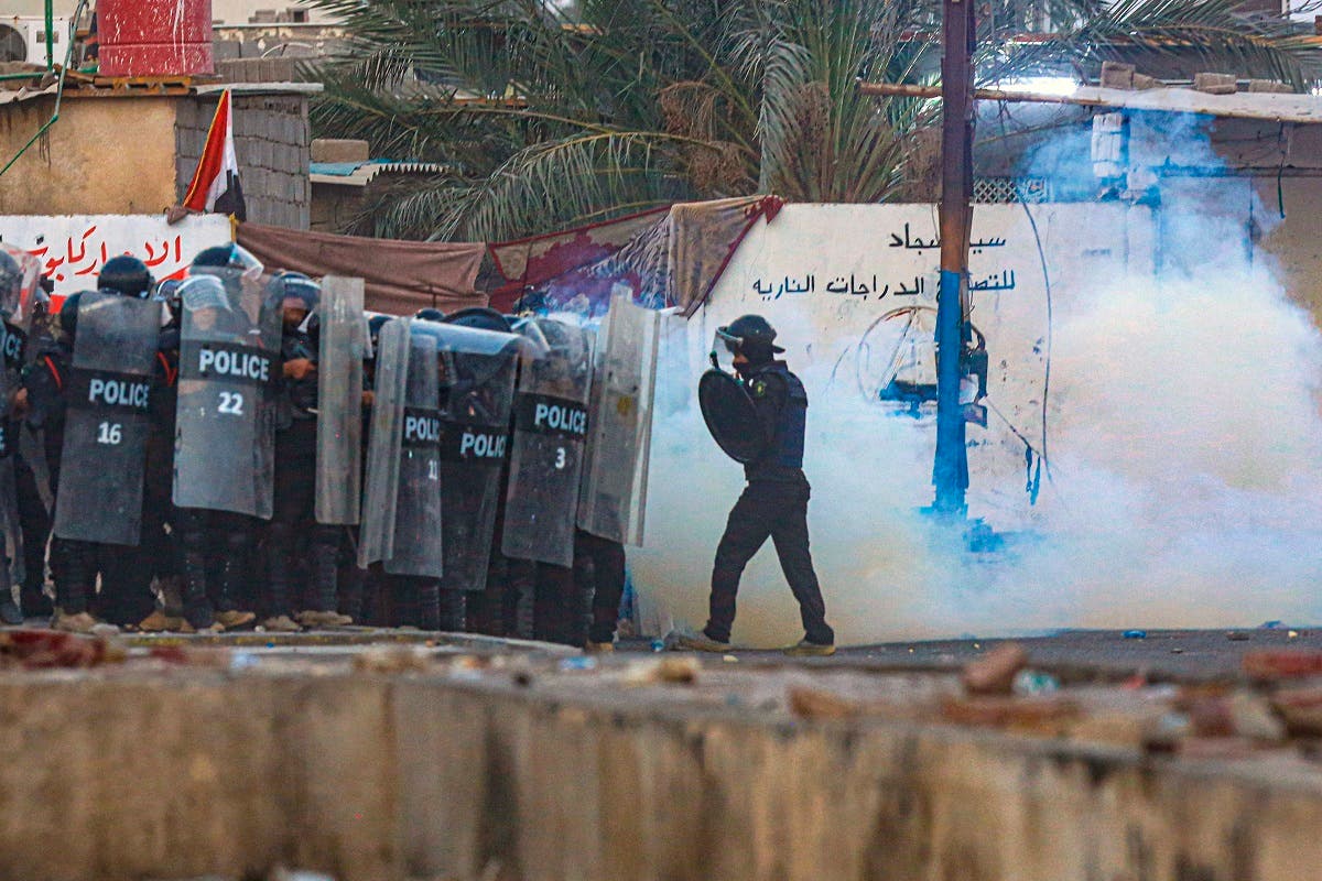 Security forces fire tear gas to disperse anti-government protesters in Basra, Iraq, Nov. 1, 2020. (AP/Nabil al-Jurani)