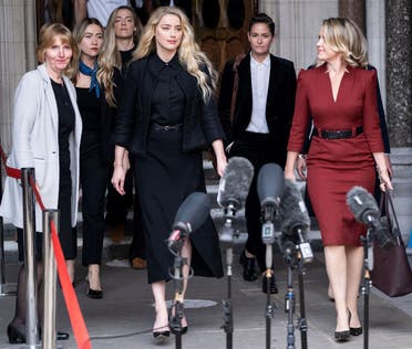 In this file photo taken on July 28, 2020 US actress Amber Heard (C) prepares to make a statement to members of the media outside the High Court in London, on July 28, 2020. (Niklas Halle’n/AFP)