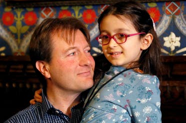 Richard Ratcliffe, the husband of jailed British-Iranian aid worker Nazanin Zaghari-Ratcliffe, sits with his daughter Gabriella during a news conference in London, Britain October 11, 2019. (Reuters)