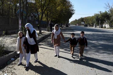 School children walk along a road near Kabul University in Kabul on November 2, 2020. (Wakil Kohsar/AFP)