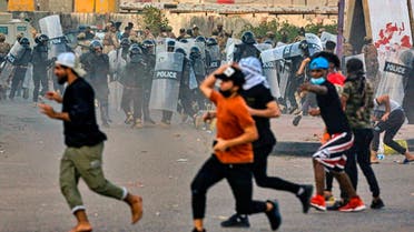Anti-government protesters throw stones toward security forces in Basra, Iraq, Nov. 1, 2020. (AP/Nabil al-Jurani)