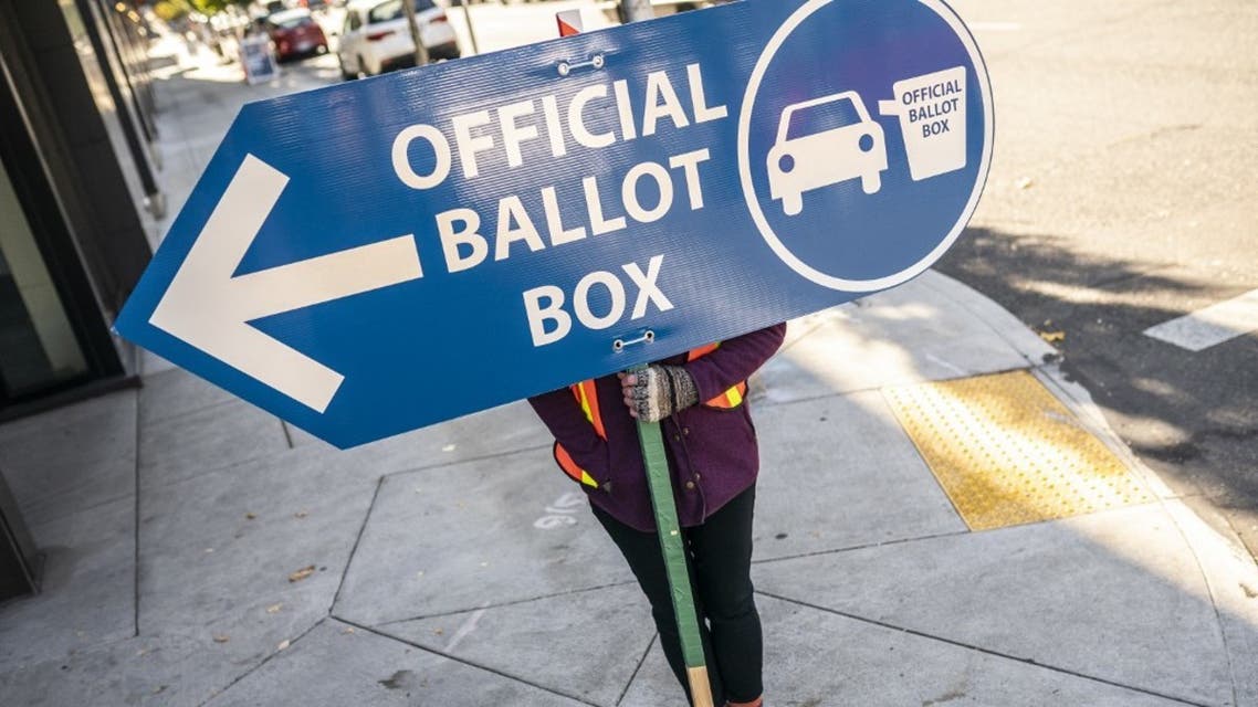 An election worker directs voters to a ballot drop off location on November 2, 2020 in Portland, Oregon. (AFP)