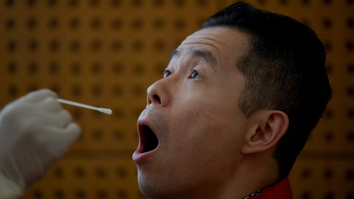 A journalist is tested for coronavirus in Beijing, China, October 22, 2020. (AFP)